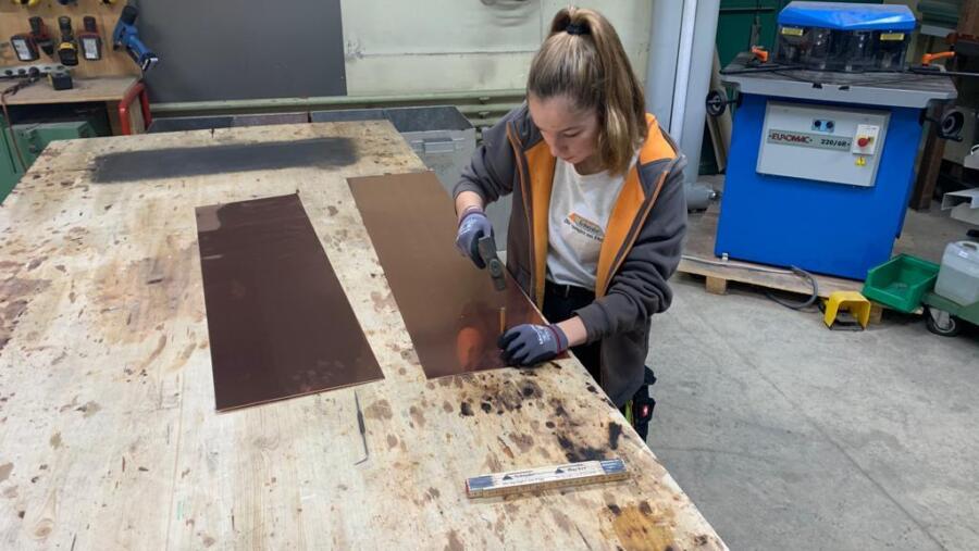 Young tinsmith during centre punching, Spenglerei Schnyder AG